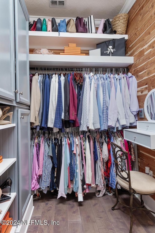 spacious closet featuring visible vents and wood finished floors