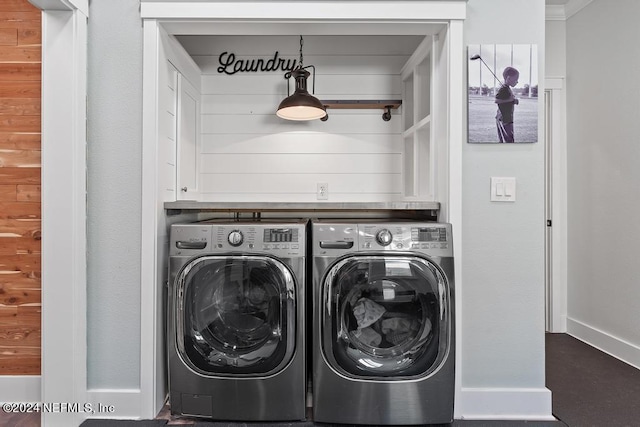 laundry area with washing machine and dryer, laundry area, and baseboards