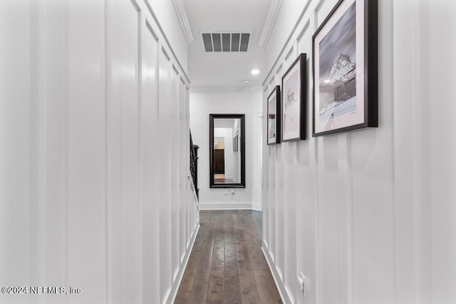 hallway with crown molding and dark wood-type flooring