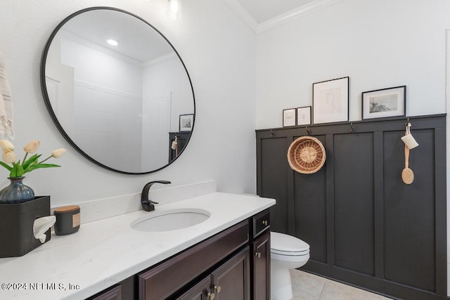 bathroom featuring vanity, crown molding, toilet, and tile patterned floors