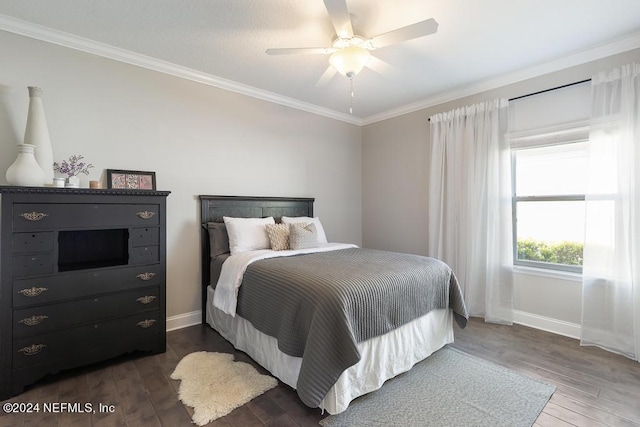 bedroom with ornamental molding, dark wood-type flooring, and ceiling fan