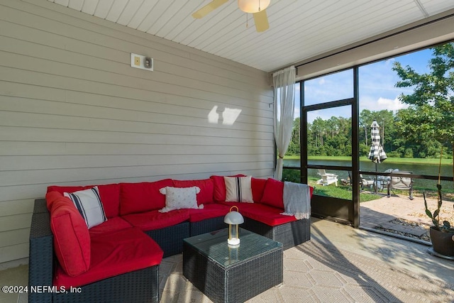 sunroom / solarium with outdoor lounge area, a ceiling fan, and a water view
