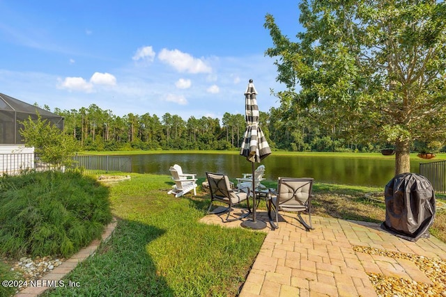 exterior space with a patio, a water view, and fence