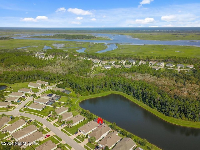 drone / aerial view with a residential view and a water view