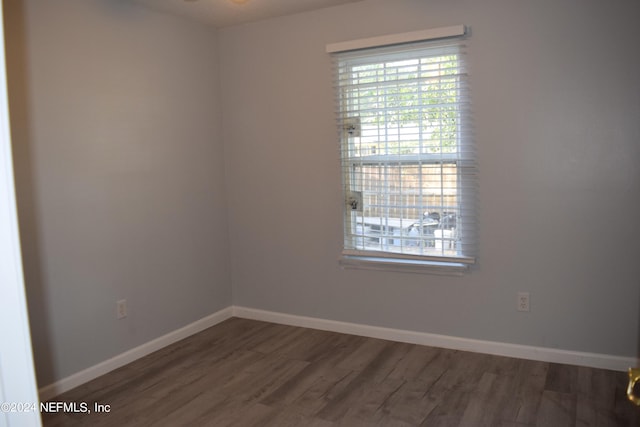 spare room with dark hardwood / wood-style floors