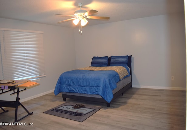 bedroom with hardwood / wood-style floors and ceiling fan