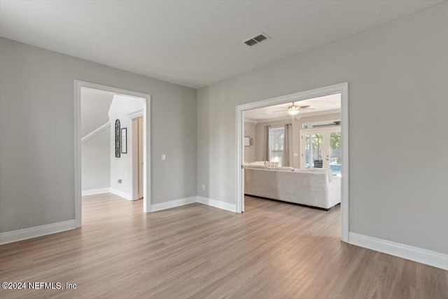 spare room featuring light hardwood / wood-style floors and french doors