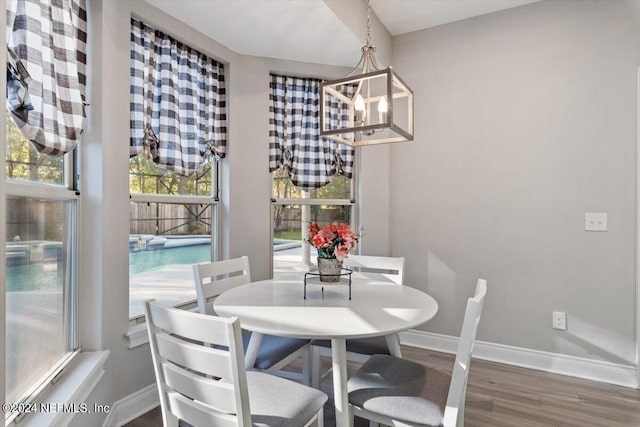 dining room featuring dark hardwood / wood-style floors and an inviting chandelier