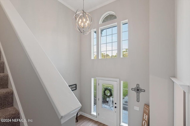 foyer entrance featuring an inviting chandelier and ornamental molding