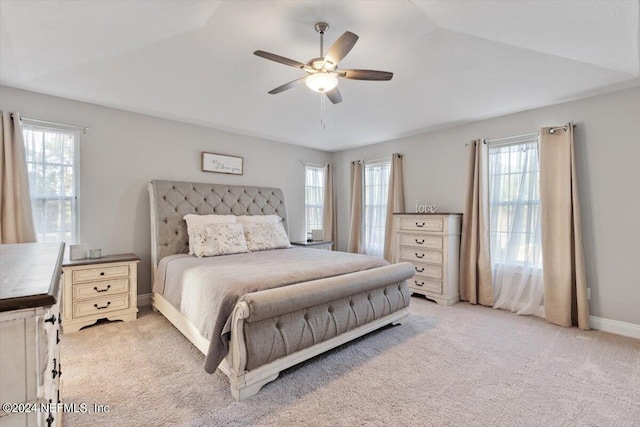 carpeted bedroom featuring ceiling fan and multiple windows