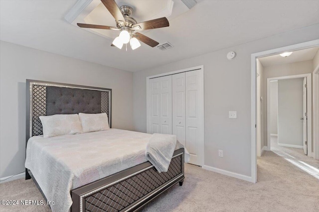 carpeted bedroom featuring a closet and ceiling fan