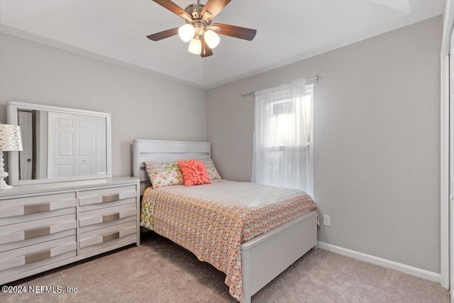 bedroom featuring light carpet and ceiling fan