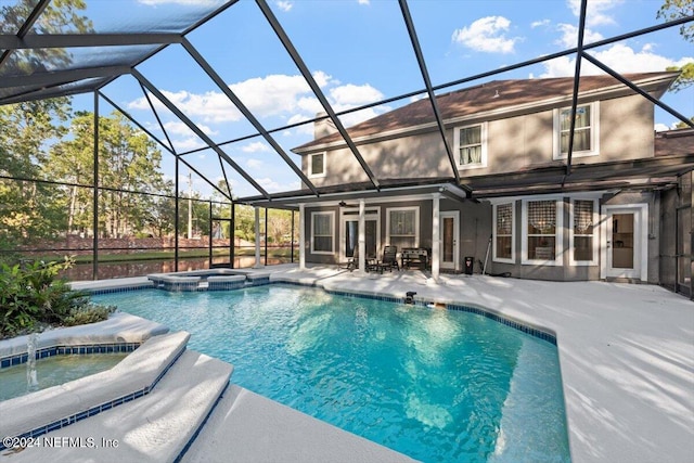 view of swimming pool featuring an in ground hot tub, glass enclosure, and a patio