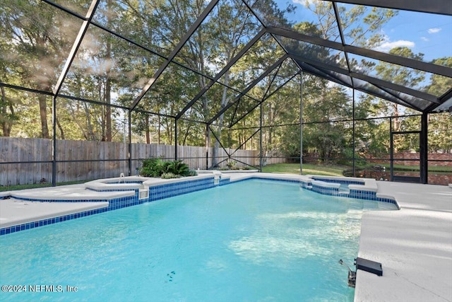 view of pool featuring an in ground hot tub, a patio, and glass enclosure