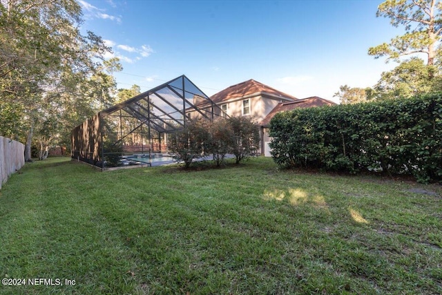 view of yard with glass enclosure