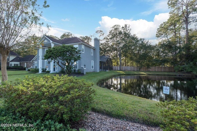 exterior space featuring a yard and a water view