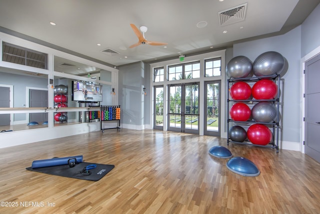 workout room with wood-type flooring, french doors, and ceiling fan