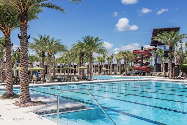 view of swimming pool with a water slide