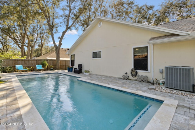 view of swimming pool featuring a patio and central AC unit