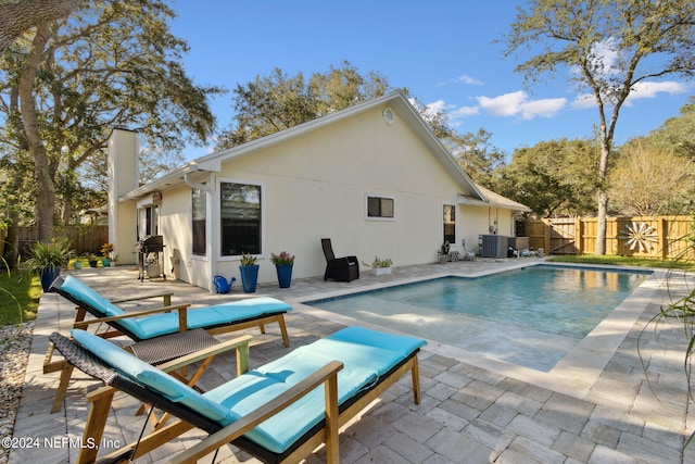 view of swimming pool with a patio and a grill