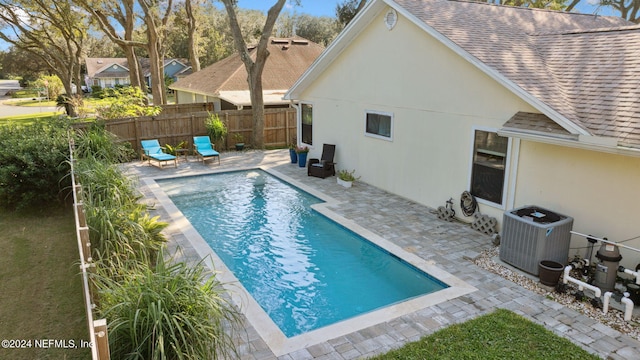 view of swimming pool with a patio area and central AC