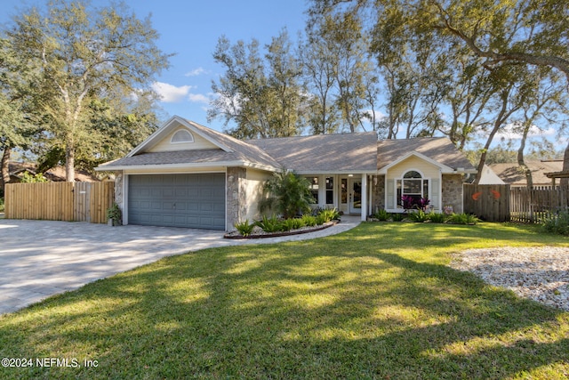 ranch-style house featuring a garage and a front lawn