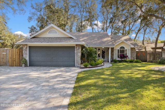 ranch-style home featuring a front lawn and a garage