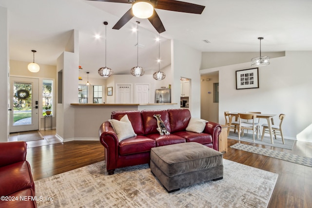 living room featuring ceiling fan, wood-type flooring, and lofted ceiling