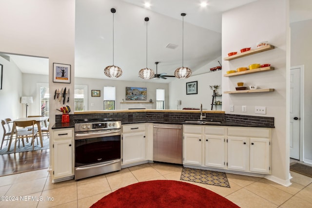 kitchen with sink, appliances with stainless steel finishes, pendant lighting, and high vaulted ceiling