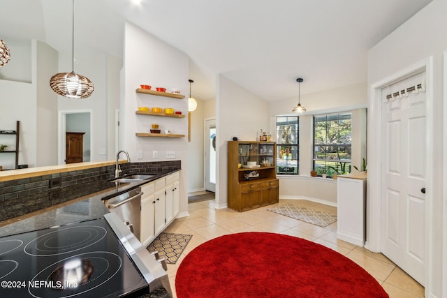 kitchen featuring pendant lighting, vaulted ceiling, sink, and stainless steel dishwasher