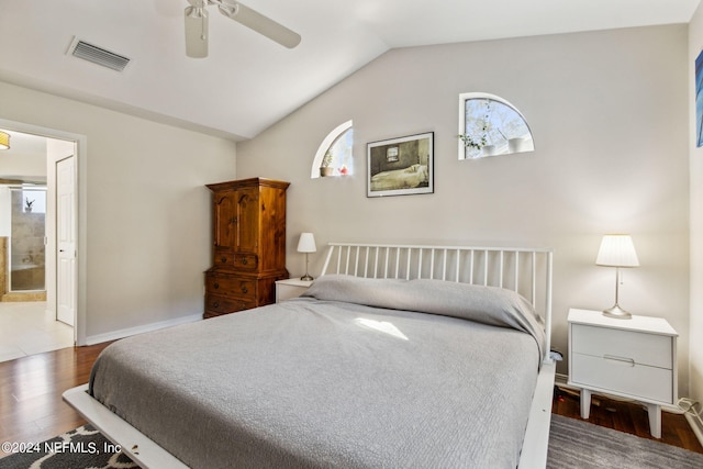 bedroom with connected bathroom, ceiling fan, lofted ceiling, and dark hardwood / wood-style flooring