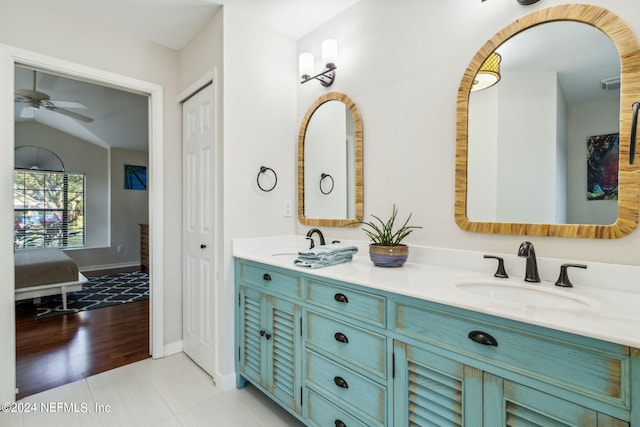 bathroom featuring vanity, lofted ceiling, and hardwood / wood-style floors