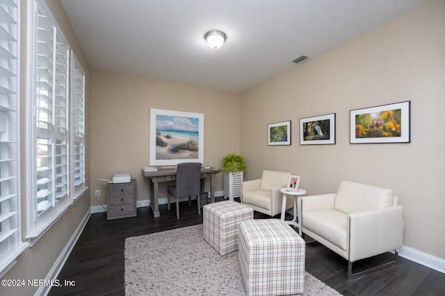 home office with dark hardwood / wood-style flooring