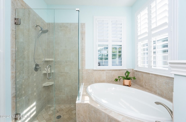 bathroom featuring separate shower and tub