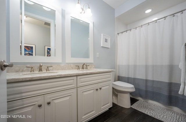 bathroom featuring a shower with curtain, vanity, hardwood / wood-style flooring, and toilet