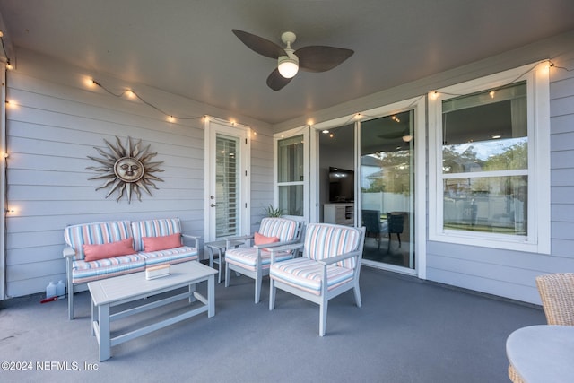 view of patio with an outdoor living space and ceiling fan