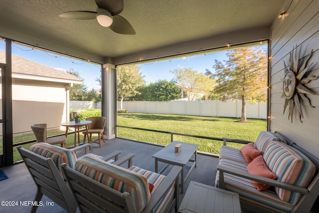 sunroom featuring ceiling fan