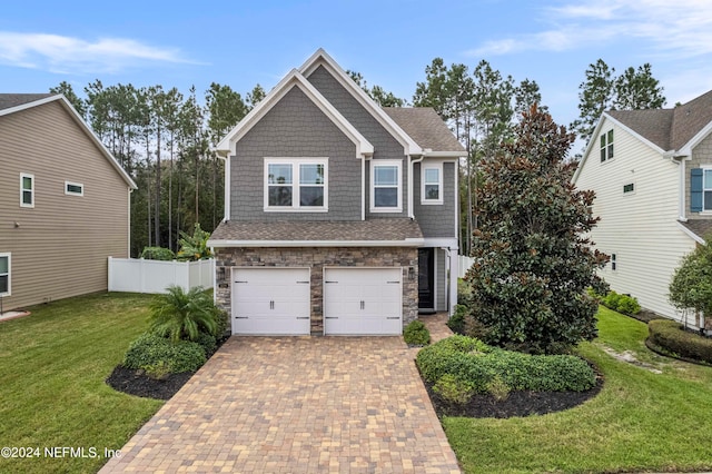 craftsman-style house with a front yard and a garage