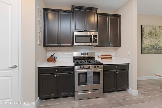 kitchen featuring tasteful backsplash, stainless steel appliances, and light wood-type flooring