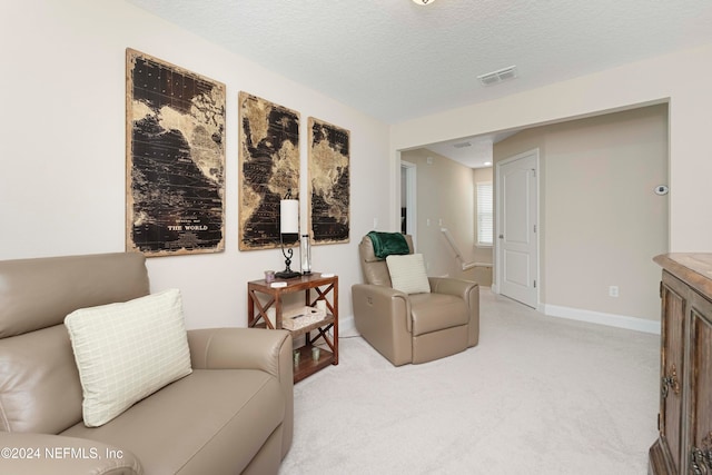 living room featuring a textured ceiling and light colored carpet