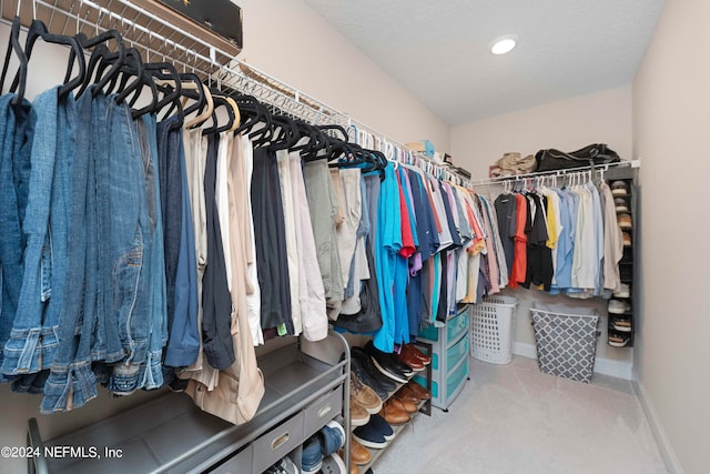 walk in closet with carpet floors