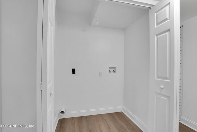 clothes washing area with electric dryer hookup, hookup for a washing machine, and wood-type flooring