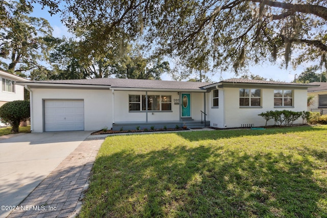 single story home with a front yard and a garage