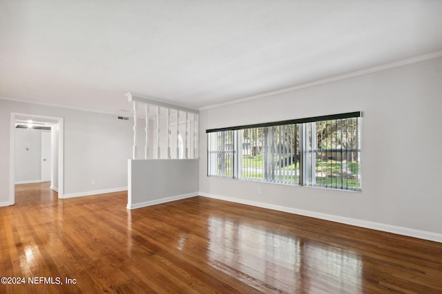 unfurnished room with crown molding and wood-type flooring