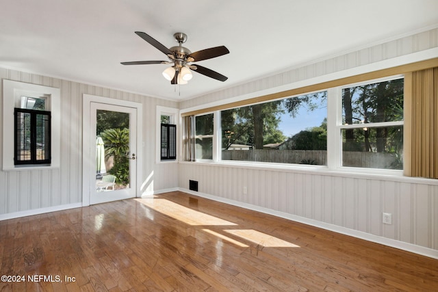 empty room featuring wood-type flooring and ceiling fan