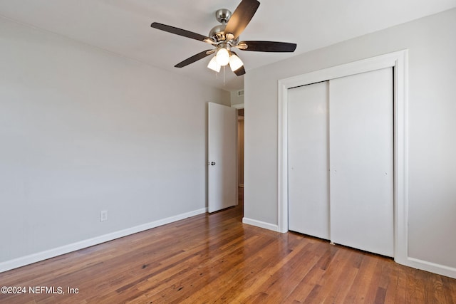 unfurnished bedroom with a closet, ceiling fan, and hardwood / wood-style flooring