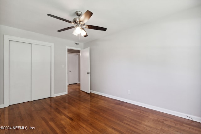 unfurnished bedroom featuring a closet, dark hardwood / wood-style floors, and ceiling fan