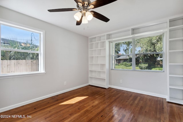 spare room with dark wood-type flooring and ceiling fan