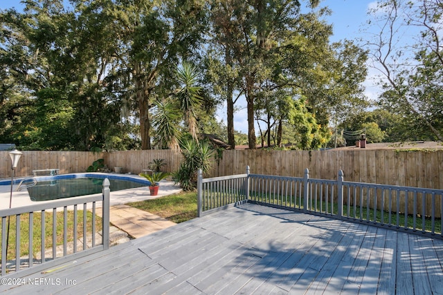 deck with a fenced in pool