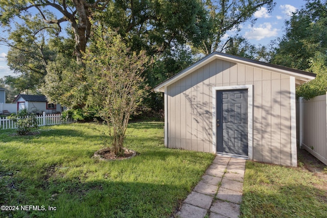 view of outbuilding with a lawn